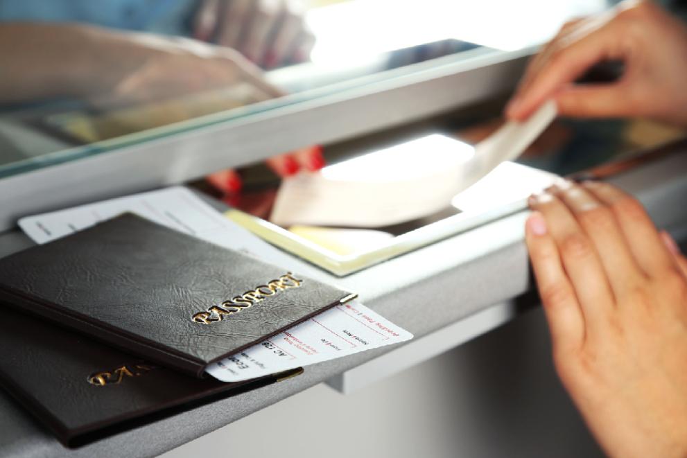Image displaying travel documents being checked at the counter